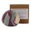 Felted shea butter soap with a label on a white surface