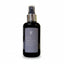 Black skincare bottle labeled 'Skin Restore' on a textured surface with a neutral background