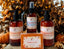 Pumpkin Chai themed skincare and soap products with pumpkins and autumn leaves in the background.